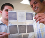 University of Utah’s Andrew Paulsen and Ajay Nahata hold up a series of terahertz frequency filters made through a process they developed using an inkjet printer.